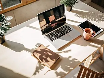 laptop on desk with coffee