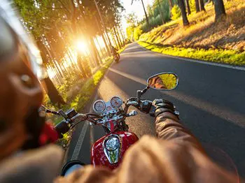 riding motorcycle on paved road